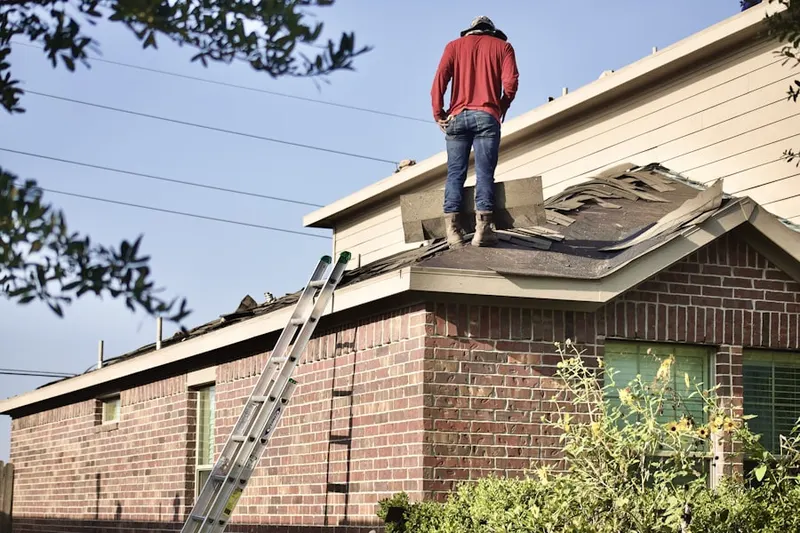 Professional roofer working on a residential roof in Glorietta